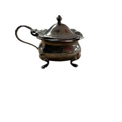 1920s silver three piece part cruet set, comprising pepper shakers, open salt with blue glass liner and a mustard pot, all upon four pad feet, hallmarked White & Hawkins, Birmingham,  , with three silver salt spoons, hallmarked 