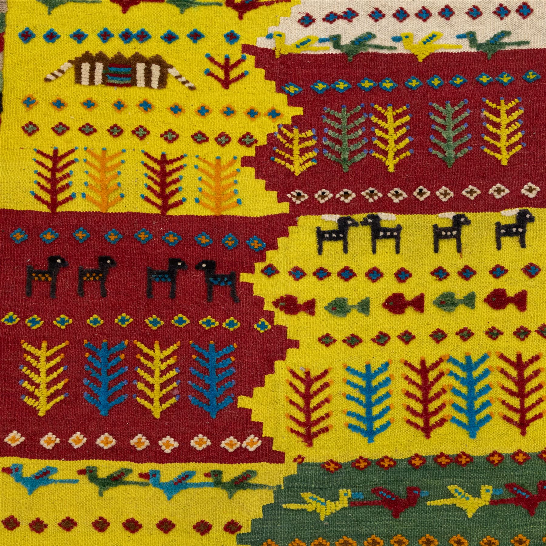 South West Persian Qashqai flatweave kilim, field arranged in bold horizontal bands of saffron yellow, madder red and deep green, decorated stylized tribal motifs including birds, animals, fish and schematic tree devices, composition arranged in a stepped asymmetrical format, with fringe ends 
