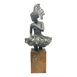 Composite bronzed sculpture, modelled as a ballerina, the skirt and head dress 
 set with glass cabochons, upon a rectangular wooden plinth, H92cm