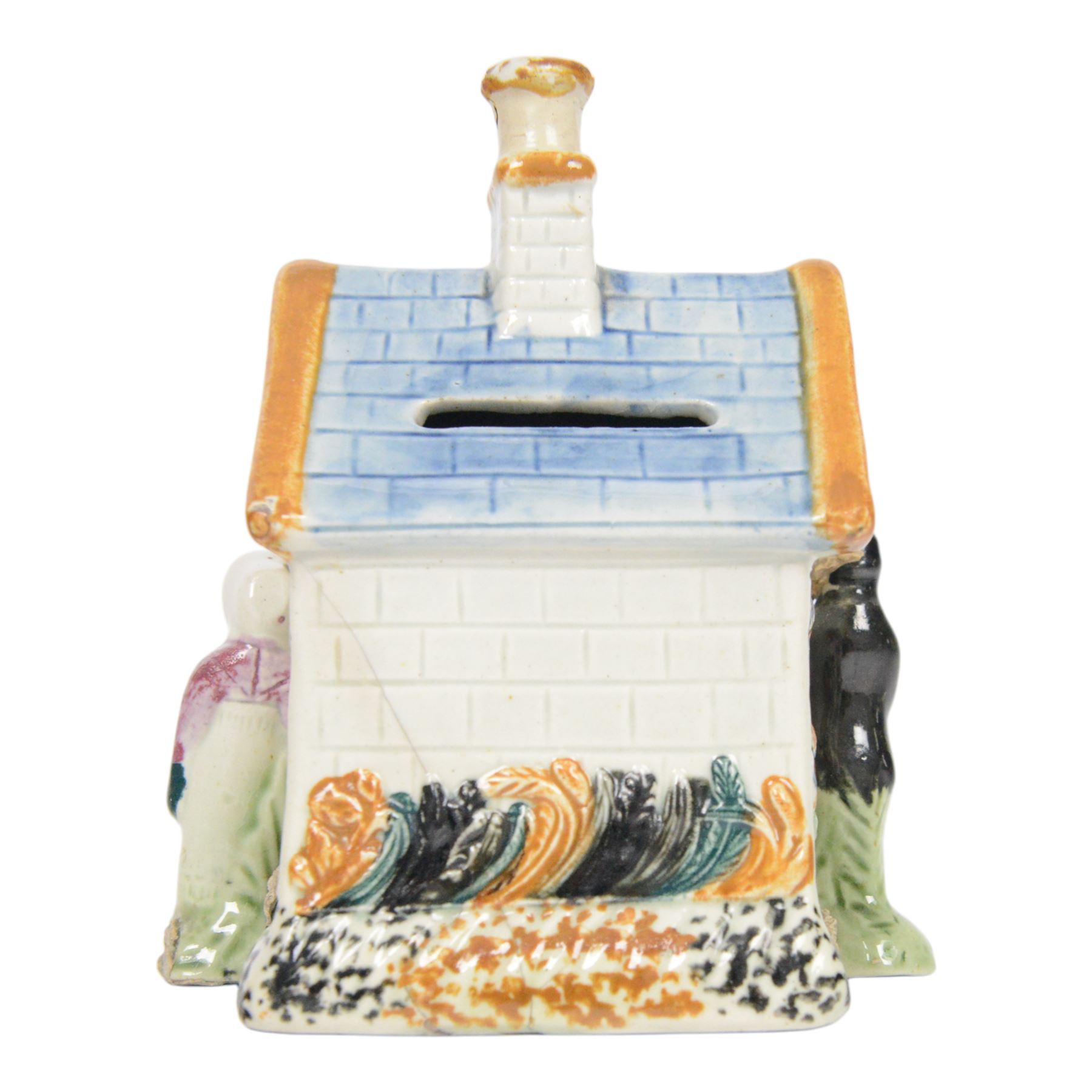 19th Century Staffordshire pearlware Prattware type money box, modelled as a houe with two figures to the front corners, H13cm