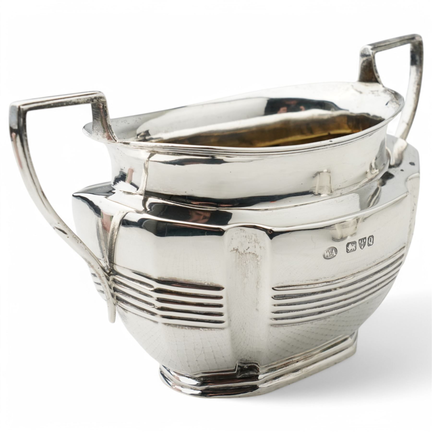 Late Victorian silver three piece tea set of panel sided oval design, the teapot with ebonised handle and lift, Chester 1898/99 Maker Florence Warden and William Aitken