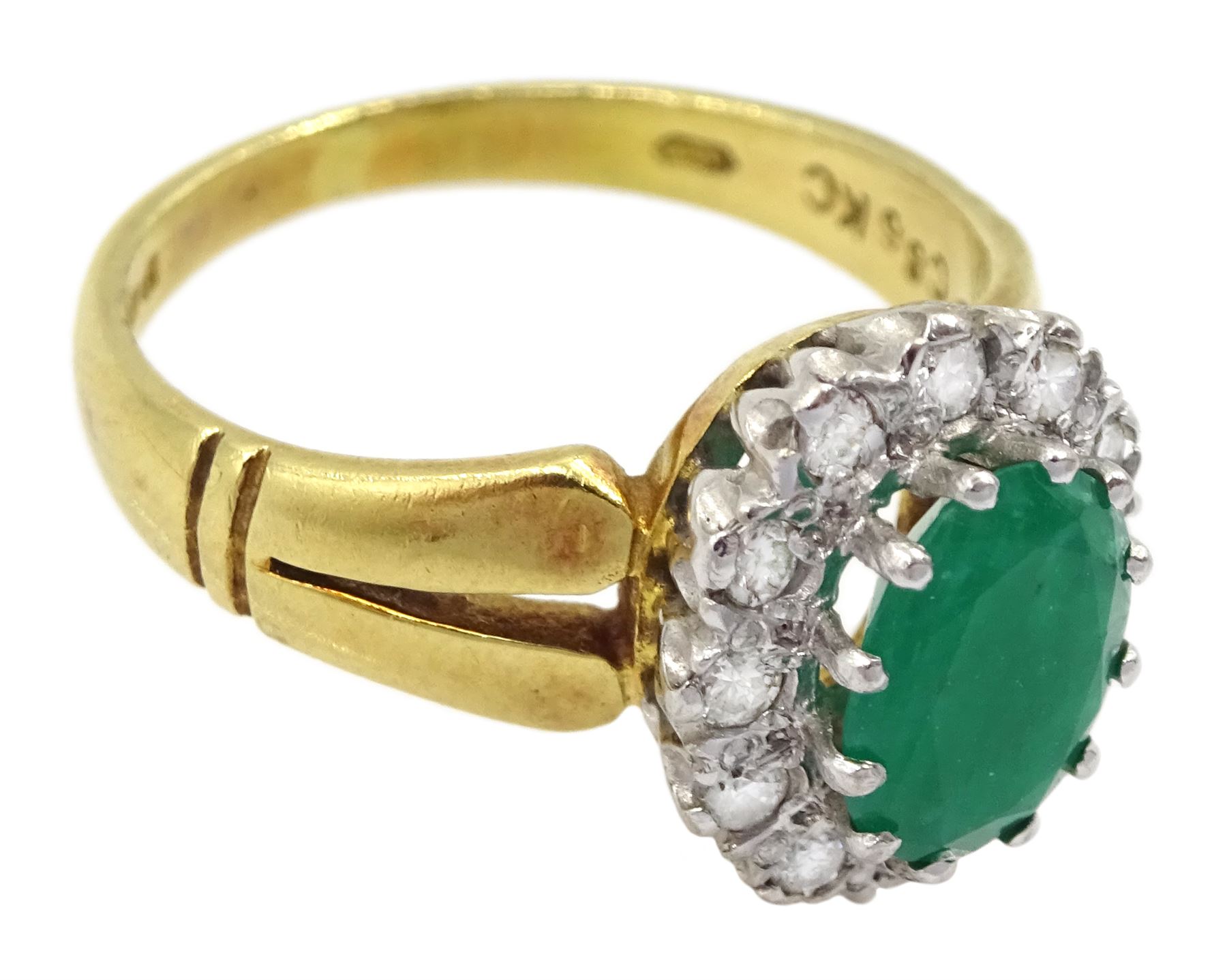18ct gold oval emerald and round brilliant cut diamond cluster ring, London 1979