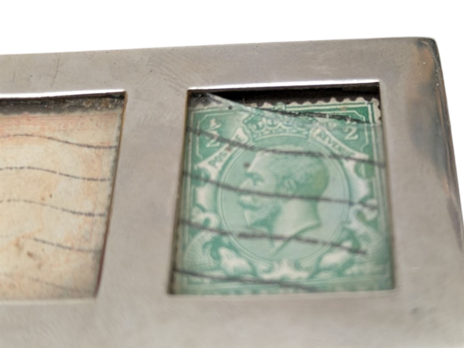 Two three division stamp boxes, the first with enamelled ladybird decoration and engraved initials to the inside of the hinged cover, the second with glass cover showing three King George V stamps