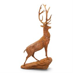 Pair of cast iron stags, upon a on moulded rocky plinth, standing alert 
