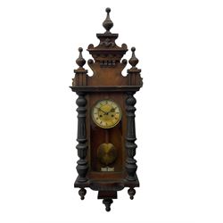 German regulator style wall clock c1900, with an eight-day spring driven movement striking the hours and half hours on a coiled gong, with a fully glazed door with flanking turned columns, decoratively carved pediment with finials, visible pendulum with beat plate.