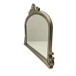 Arch top overmantle mirror in silvered frame, shell pediment with scroll decoration