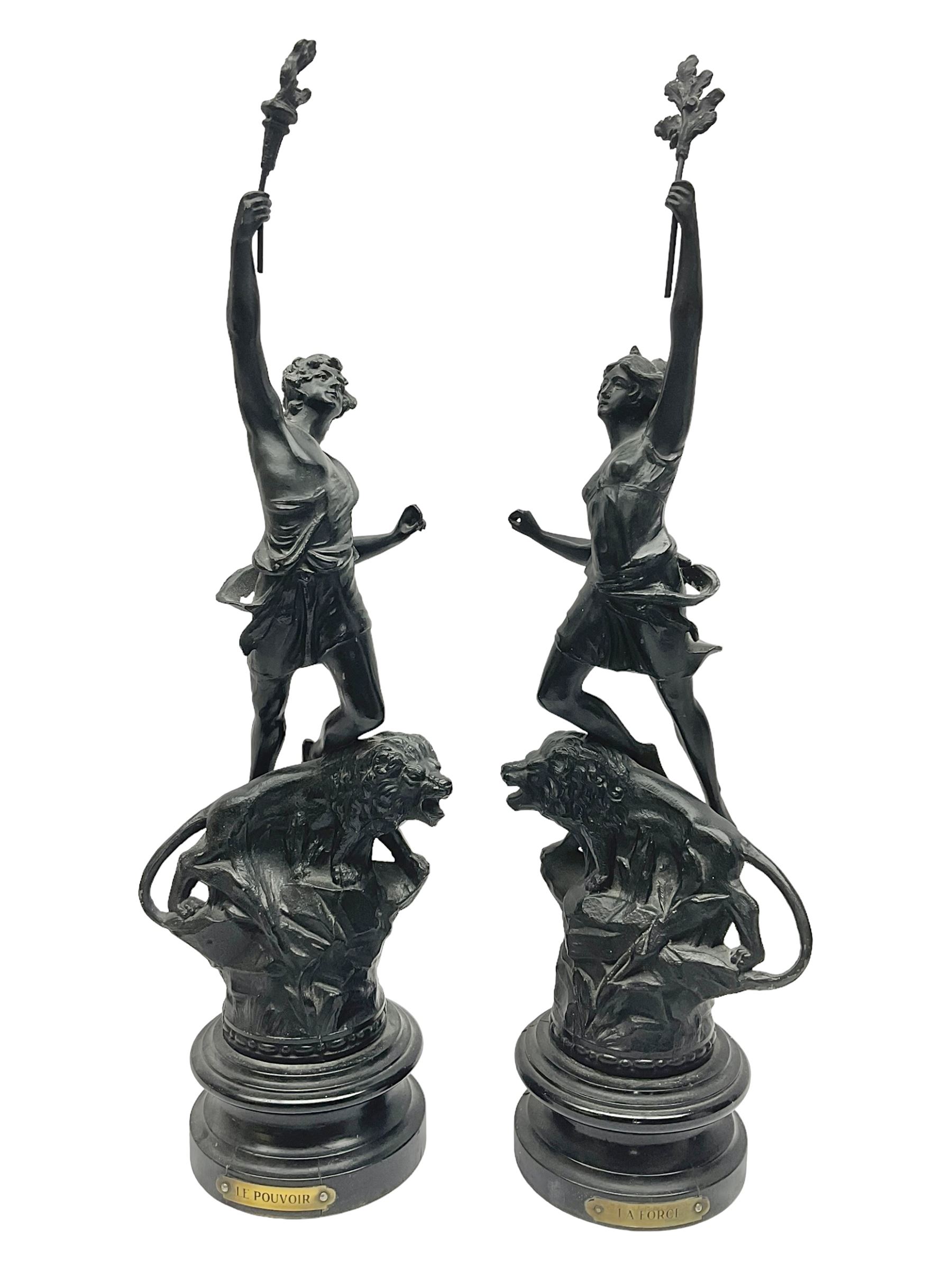 Pair of spelter figures, Le Force and Le Pouvoir, modeled as figures standing on lions, arms held aloft, H51cm 