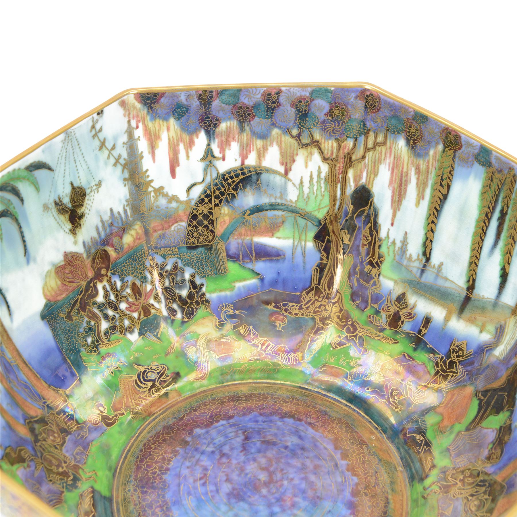 Early 20th century Wedgwood Fairland lustre bowl, circa 1920, of octagonal form, designed by Daisy Makeig-Jones, the exterior decorated in the Castle on the Road pattern, the interior decorated in the Fairy in a Cage pattern, pattern no Z5125, with printed marks beneath, H11cm D22.5cm
