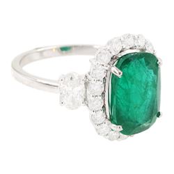 18ct white gold emerald and diamond cluster ring, single cushion cut emerald of approx 2.45 carat, surrounded by eighteen round brilliant cut diamonds, with a single oval cut diamond set either side, stamped, total diamond weight approx 1.05 carat