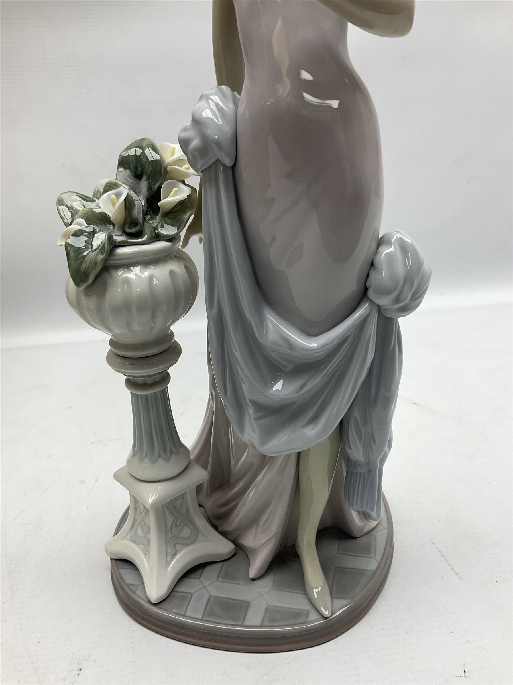 Four Lladro figures, comprising Touch of Class no 5377, Boy Student no 4517, Ocean Beauty no 5785 and Carnival Couple no 4882, largest example H45cm