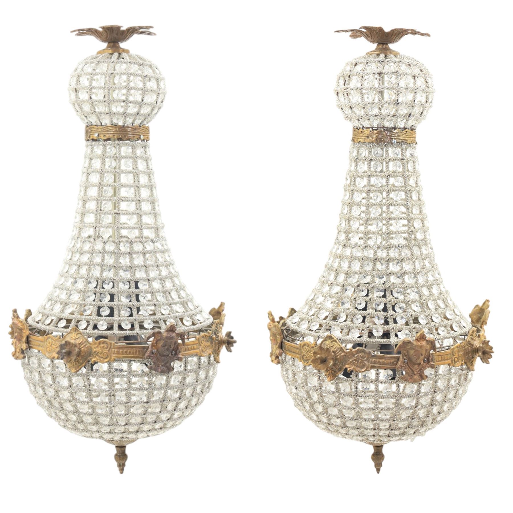 Late 19th century pair of French Empire gilt metal and cut glass bag chandelier, the tapering body formed of faceted glass button drops, with lobed lower bowl, cast foliate and mask mounts, surmounted by a bulbous upper section and terminating with a pendant finial