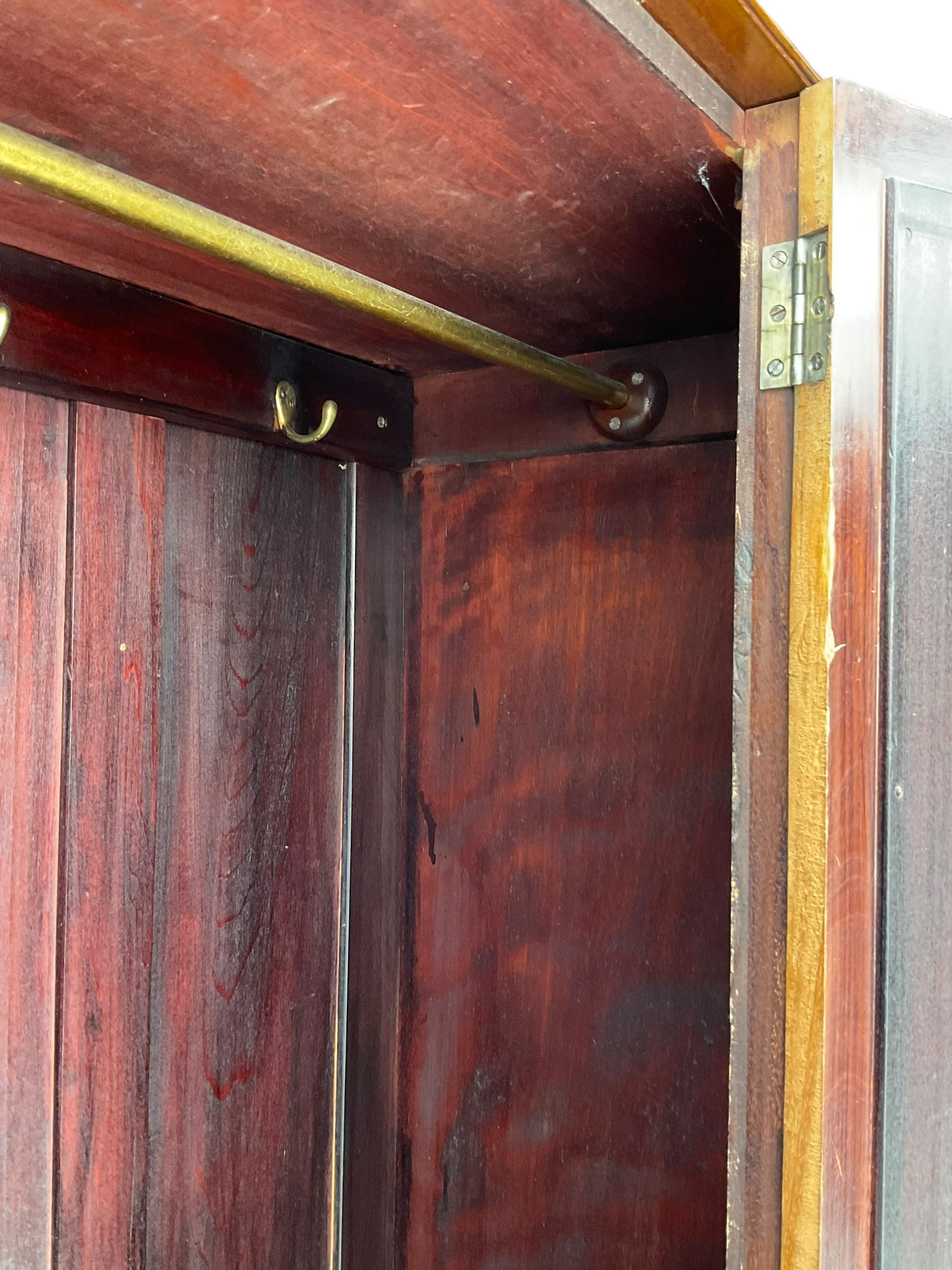 Edwardian inlaid mahogany wardrobe, projecting moulded cornice over central bevelled mirror glazed door, panelled uprights inlaid with trailing bellflowers and foliate decoration, the skirted base fitted with single drawer 