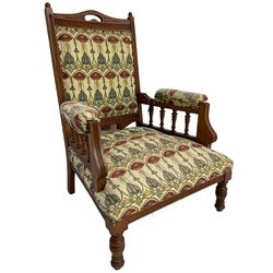 Early 20th century armchair, back and sprung seat upholstered in Art Nouveau patterned fabric, raised on ring turned supports, the frame with all-over reeded decoration
