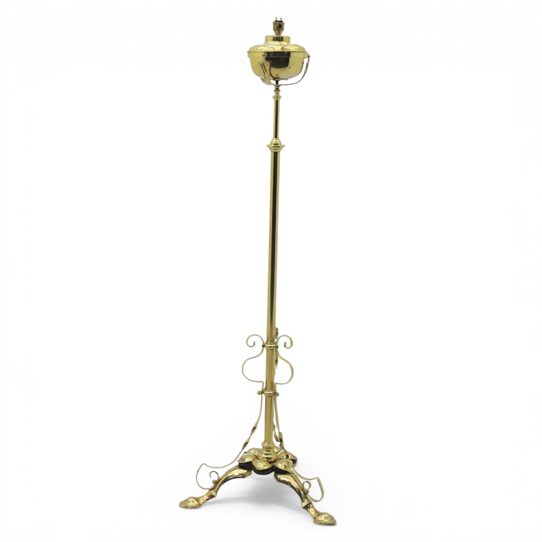 20th century brass standard lamp, urn form reservoir top with hinged cover, on a slender column with knopped detail, the stem fitted with scrolling supports, raised on a triform base with shaped cabriole supports terminating in pad feet