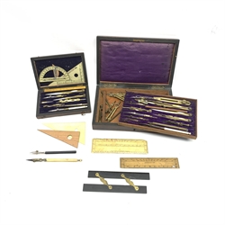  Two sets of early 20th century draughtmans brass and nickel drawing instruments, some with bone or ivory handles in fitted rosewood cases, with some additional compasses and dividers, boxwood and other parallel rulers etc, case W23cm x 14cm max (2) Provenance: Property of a former coachbuilder  