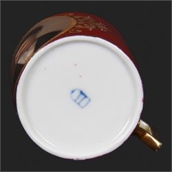 Late 19th century Vienna style coffee can and saucer, the cup with oval panel containing hand painted portrait of a gentleman, within a gilt foliate detailed surround, and upon a burgundy ground, the saucer with gilt band and sprigs upon a burgundy ground, with spurious shield mark beneath, cup H5cm saucer D12cm