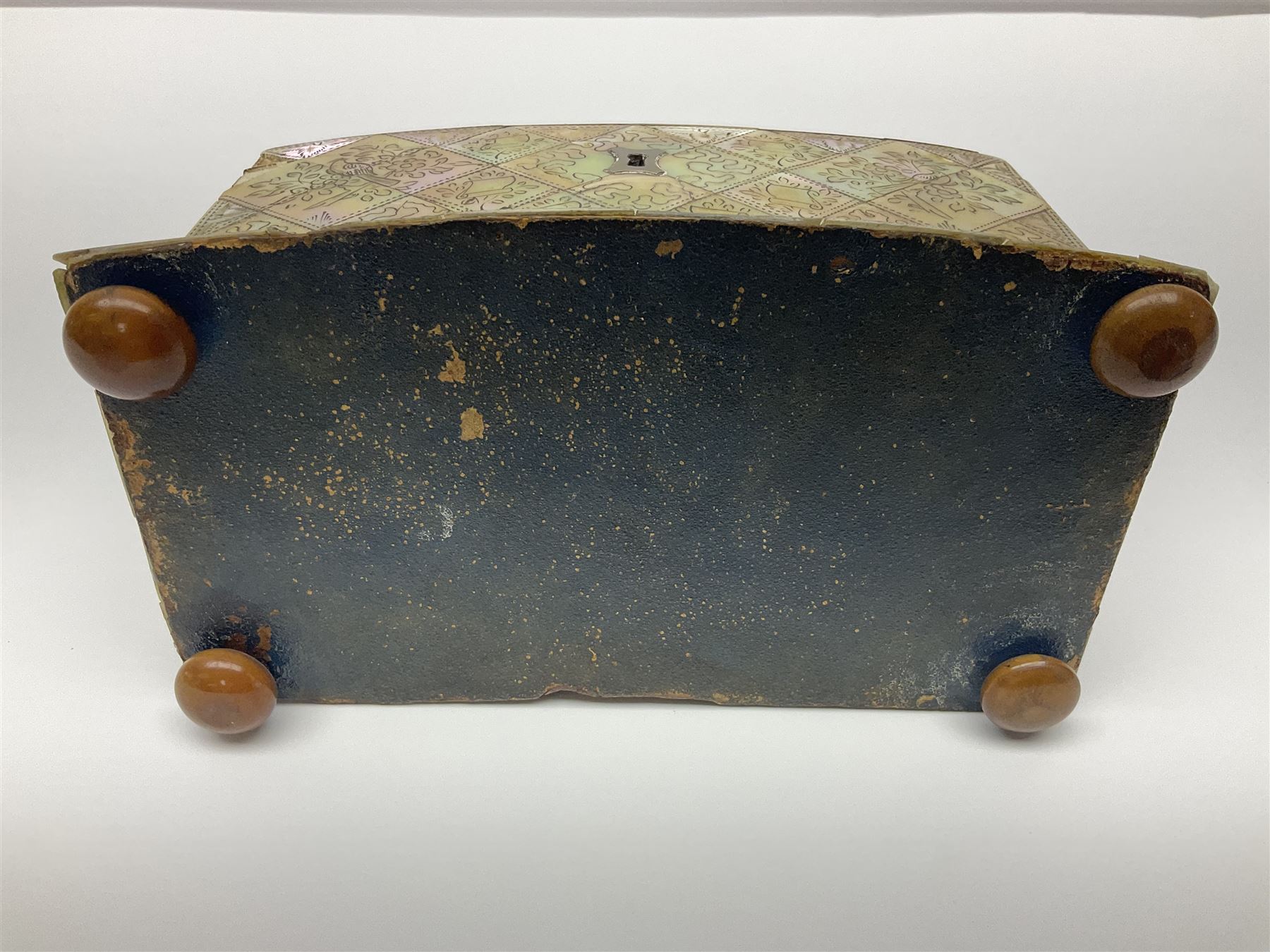 Victorian mother of pearl tea caddy, of rectangular bow-fronted form, the body with floral, bird and geometric engraved mother of pearl panels, white metal shield plaque to the cover inscribed with the initials G.J.A and similar escutcheon, the two division interior with ivory edging and two panelled mother of pearl lids, on four vegetable ivory bun feet L20cm, together with a similar style mother of pearl card case (2) This item has been registered for sale under Section 10 of the APHA Ivory Act