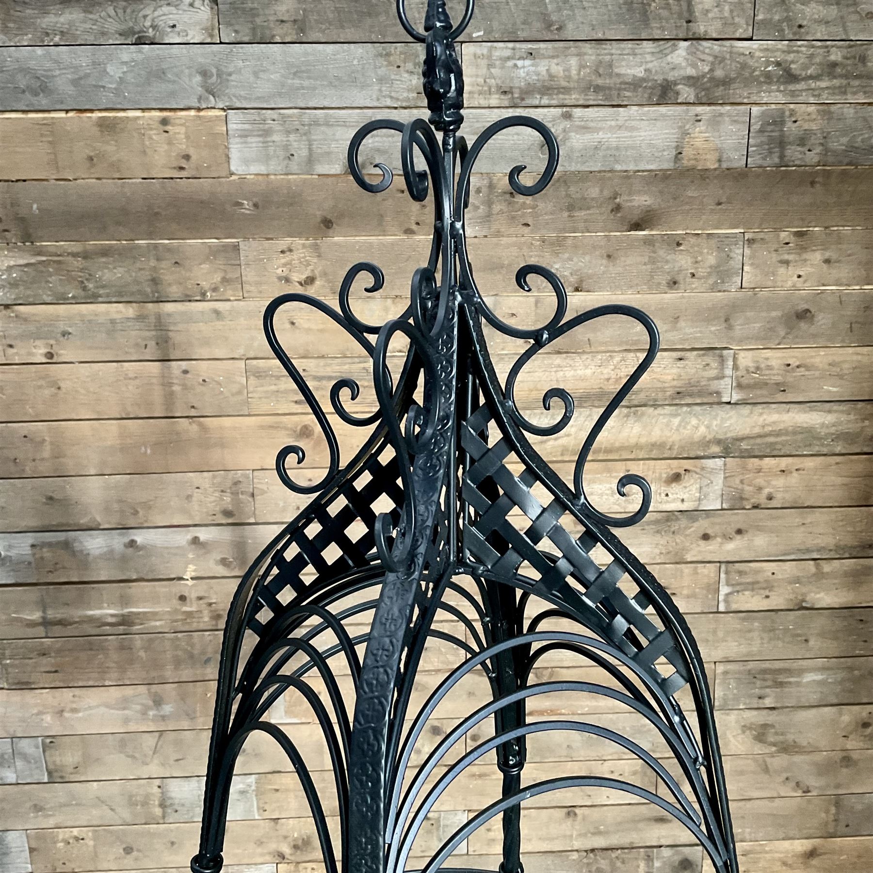 Pair of black finish wrought metal hanging baskets, with brackets