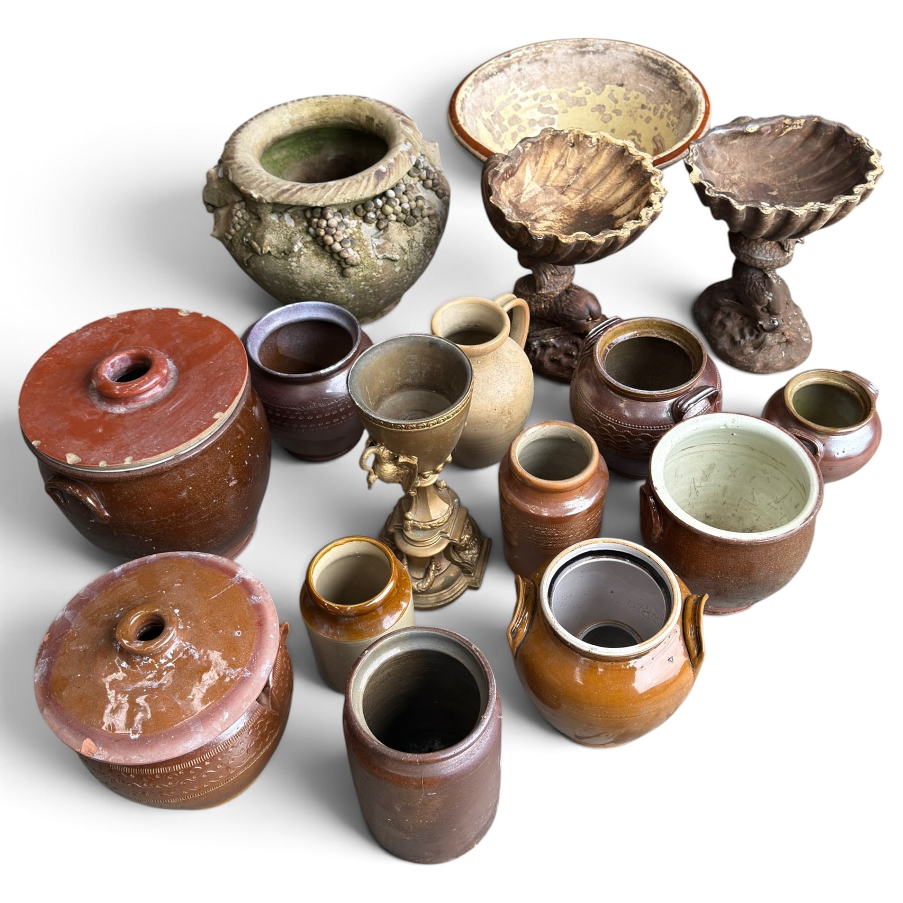Large assorted collection of glazed stoneware jars and planters, with two lidded crocks, a brass urn and three decorative garden planters, including a pair of shell-form examples