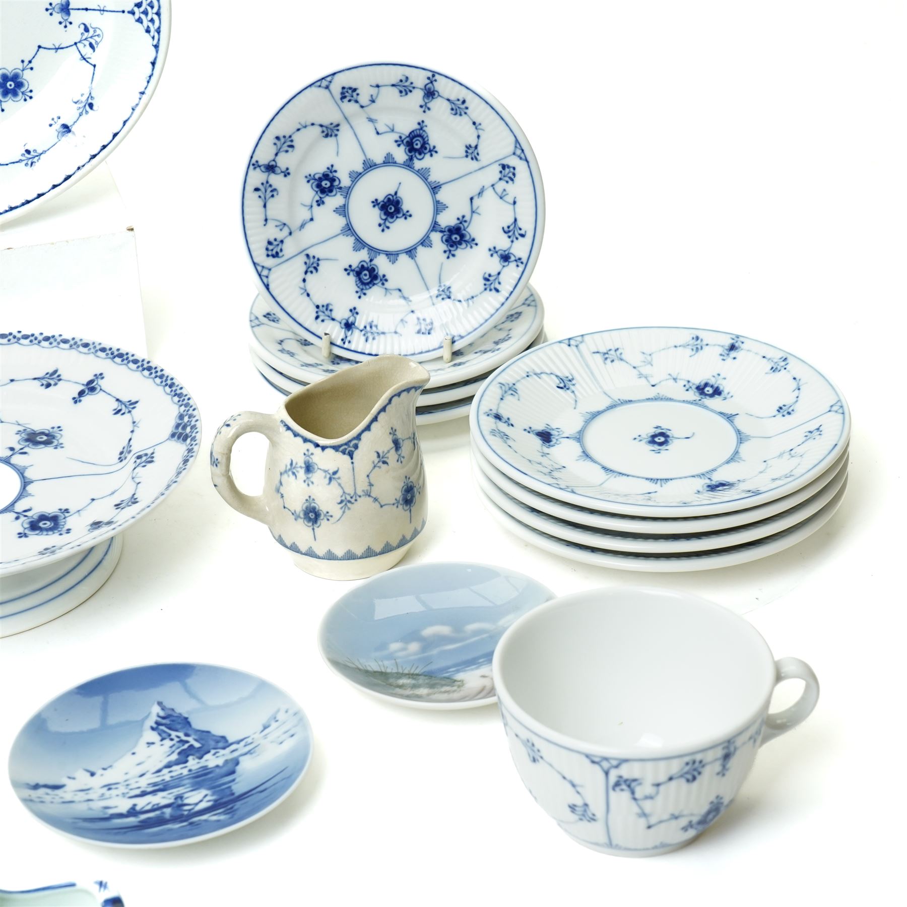 Royal Copenhagen onion pattern low comport, three breakfast cups and five saucers, oval platter, four tea plates, Munich 1972 Olympics plate, and four other blue and white items
