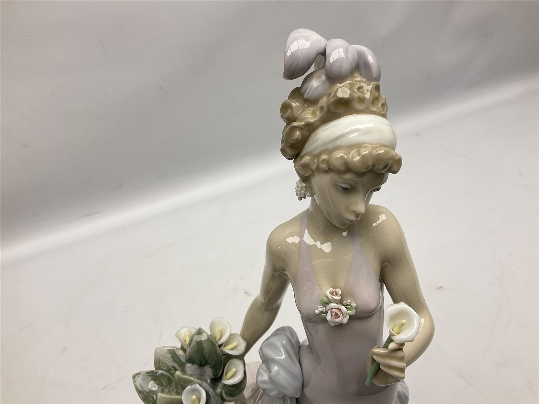 Four Lladro figures, comprising Touch of Class no 5377, Boy Student no 4517, Ocean Beauty no 5785 and Carnival Couple no 4882, largest example H45cm