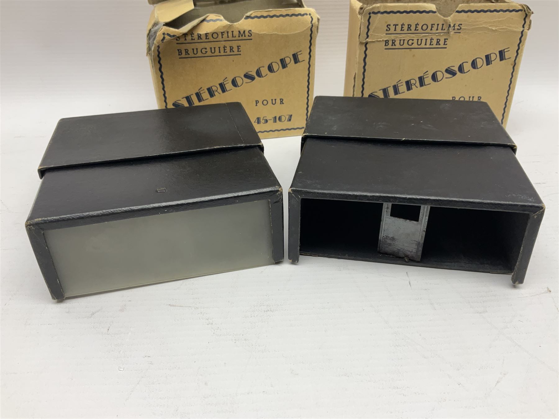 Two Stereofilms Bruguiere stereoscopes with seven boxes of related stereo positive slides to include one colour example entitled ‘Si Versailles m’etait conte’ Serie No.1, all in original boxes
