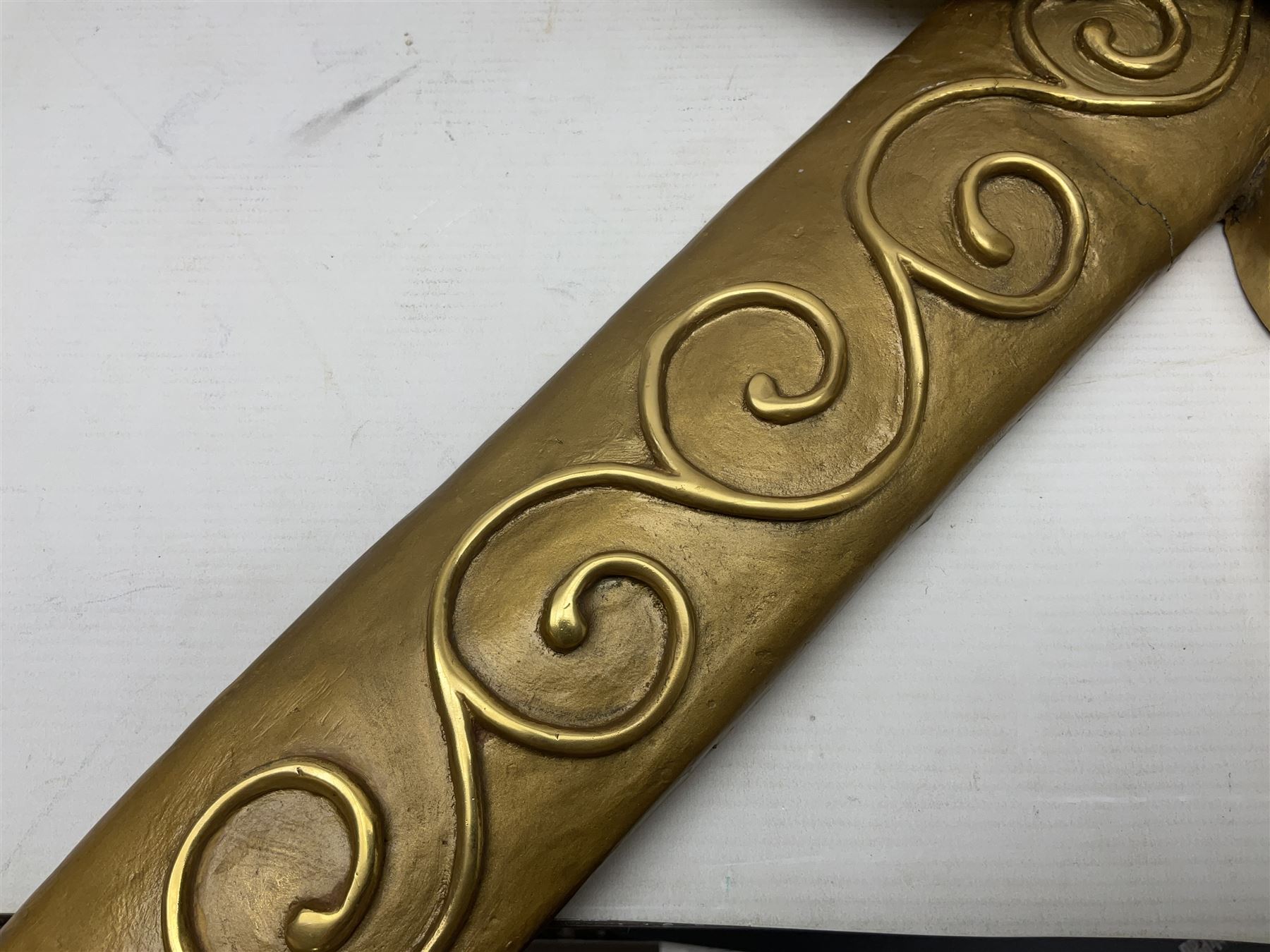 Gilt state emblem for Oman, a sheathed khanjar dagger superimposed above pair of crossed swords and belt and a seperate crown, main emblem H84cm, W83cm, crown H35cm, W33cm
Provenance by vendor repute: The emblem was previous mounted above HM's throne, in the main majalis, of the HM Royal Yacht AL Said, until 1985 when HM Sultan Qaboos ordered the upgrading of all state emblems, The emblem was gifted to the vendor who worked for the Sultans Royal Yacht Squadron