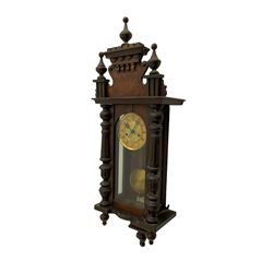 A late 19th century German wall clock c1880 with an 8-day HAC spring driven movement striking the hours on a coiled gong, in a mahogany case with a tall pediment and deeply turned columns flanking a full-length glazed door, with a two-part dial with a gilt centre and ivorine chapter, with Roman numerals, minute track and pierced gothic designed hands, spun brass faced pendulum and beat plate. With Key.



