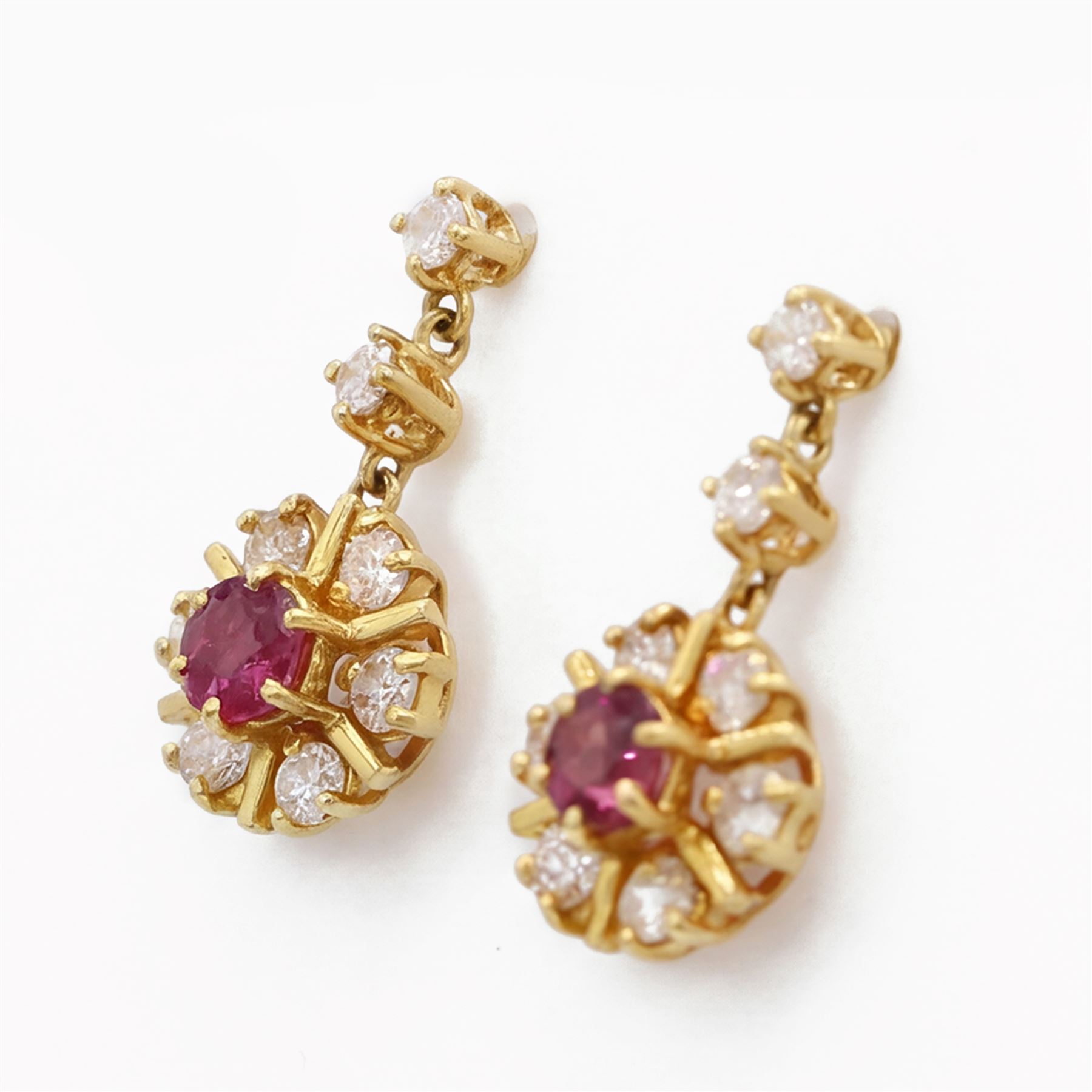 Pair of 18ct gold ruby and diamond pendant earrings, each stud set with a single round cut ruby, surrounded by six round brilliant cut diamonds, suspending from two further round brilliant cut diamonds, total ruby weight approx 0.60 carat, total diamond weight approx 1.10 carat