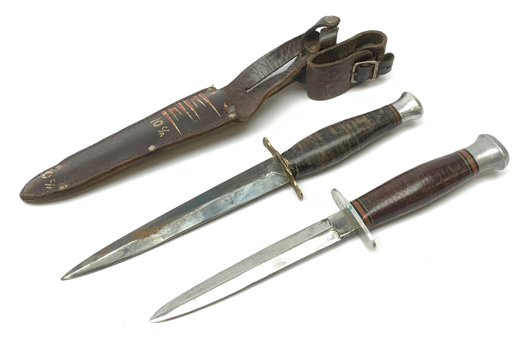 American WW2 type fighting knife with 14cm steel double edged blade, brass crosspiece, leather