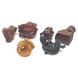 A group of six Japanese carved wooden netsukes modelled in various forms, comprising rabbit, temple dog, snake, and three nude female figures. (6). 