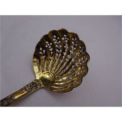 Victorian silver-gilt sugar sifting spoon, with gilded pierced shell shaped bowl, the handle decorated in relief with classical greek figures amongst fruiting vines, hallmarked Henry John Lias & James Wakely, London 1874,  L16cm, contained within tooled leather silk and velvet lined fitted case
