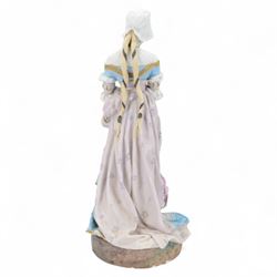 Large late 19th century French bisque figure, in the manner of Jean Gille, modelled as a female figure in high neck floral gown and bonnet, upon a naturalistically detailed circular base, overall H65.5m