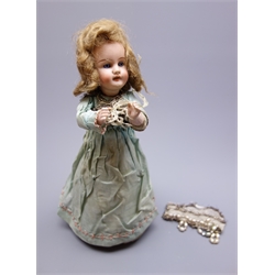 Early 20th century French Henri Rostal Mon Tresor bisque head musical pull-along doll, with blue glass eyes, open mouth with teeth, blonde wig and bisque lower arms, wearing original silk dress on conical base with three inset metal spoked wheels, H31cm   