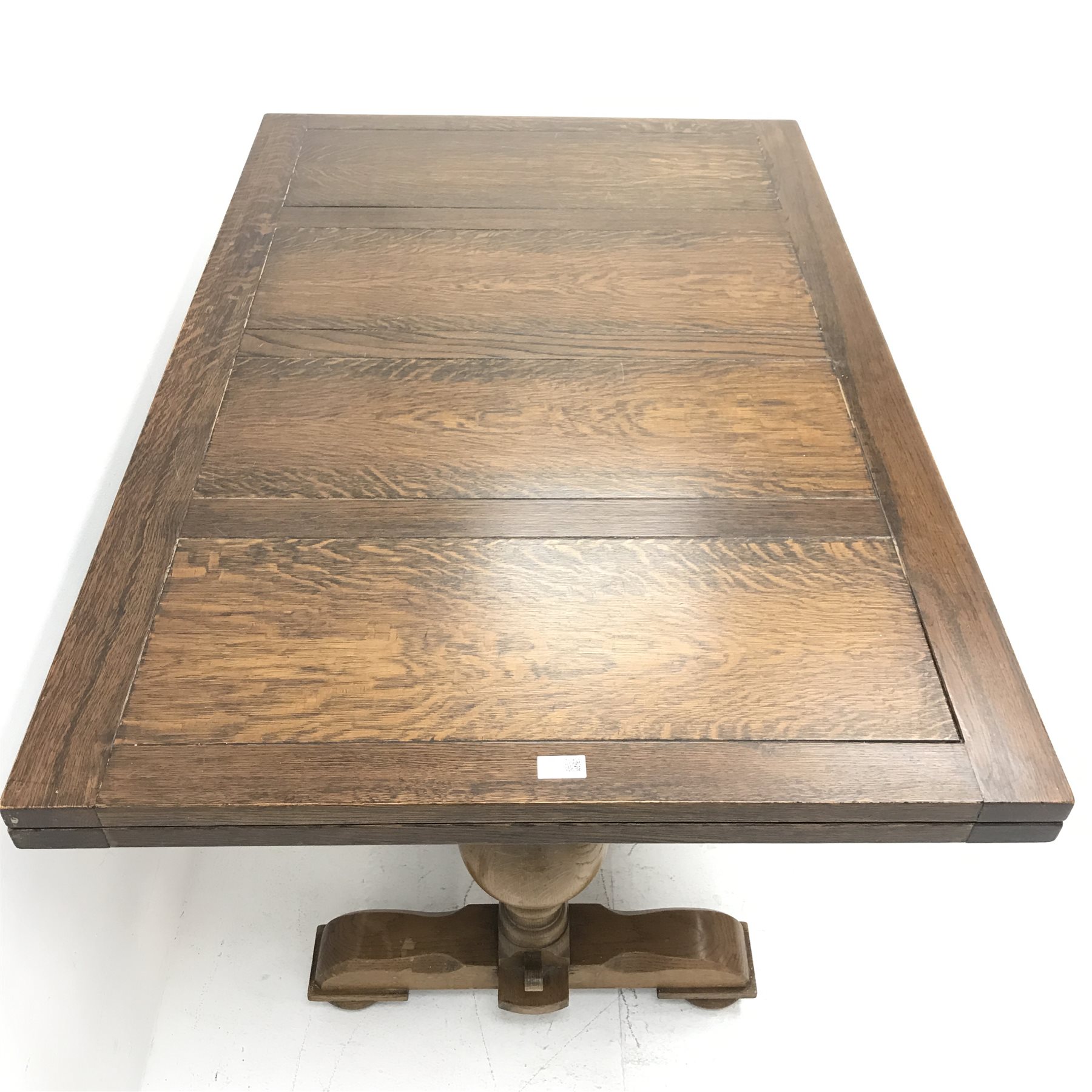 E. Gomme Ltd of High oak drawer leaf dining table, two baluster