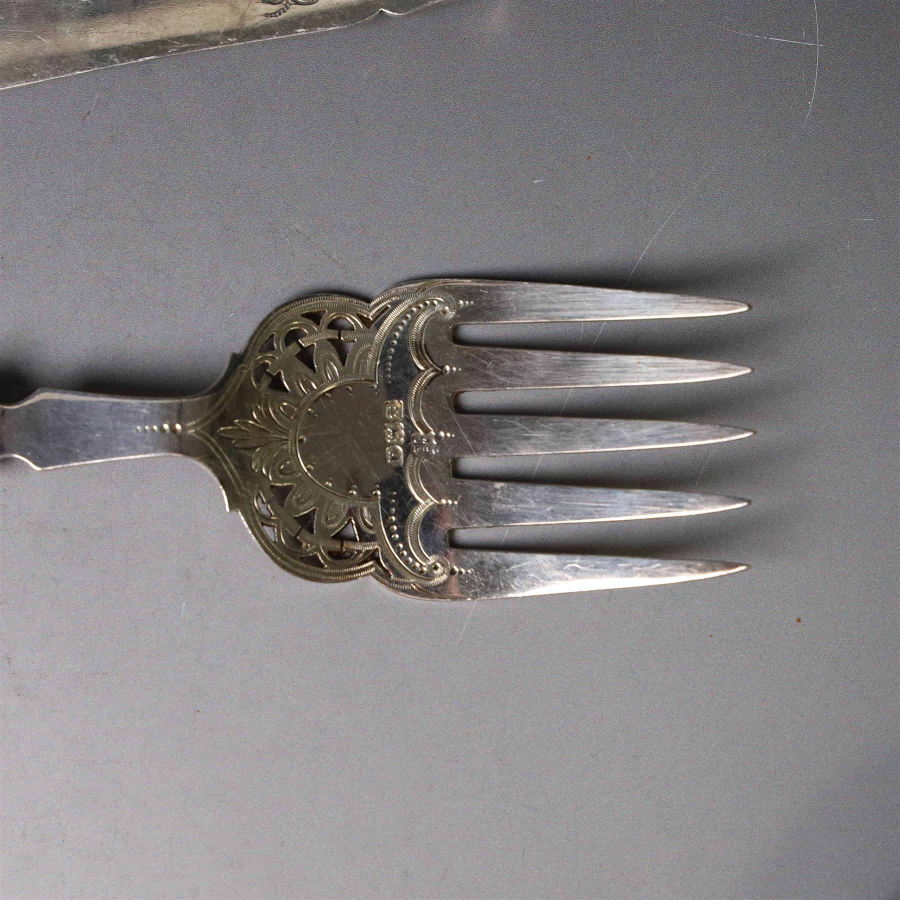 Pair of late Victorian silver fish servers, each with pierced and engraved geometric decoration, hallmarked Goldsmiths & Silversmiths Co, London 1896, handles removed, contained within fitted case
