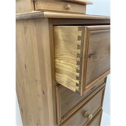 Solid pine five drawer pedestal chest, shaped plinth base (W62cm, D45cm, H134cm), together with pine swing mirror