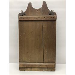 George III oak spoon rack and candle box, the rectangular backplate with shaped  pediment and two six aperture spoon racks, above a candlebox with hinged cover, with various brass spoons and a pair of brass candle snuffers, H56.5cm, W35cm, D14cm 