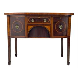 George III inlaid mahogany bow-front sideboard, figured top with satinwood crossbanding, central drawer over tambour front cupboard with fan inlaid spandrels, flanked by two cupboards, on square tapering supports with spade feet, inlaid throughout with satinwood banding and panels 