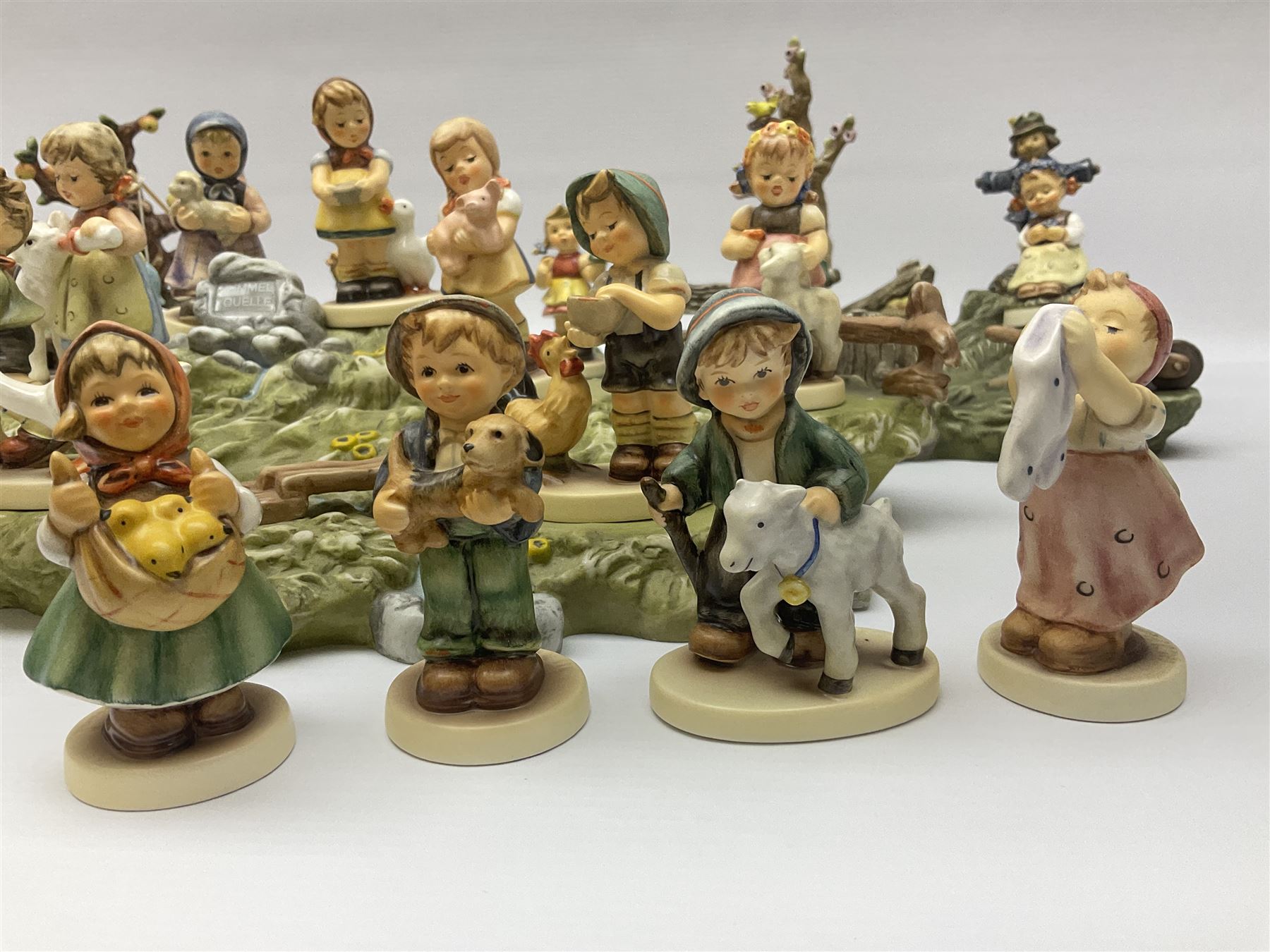 Collection Hummel figures by Goebel, together with three hummel landscapes, Hummel Quelle, Hummel Weiher and Hummel Garten