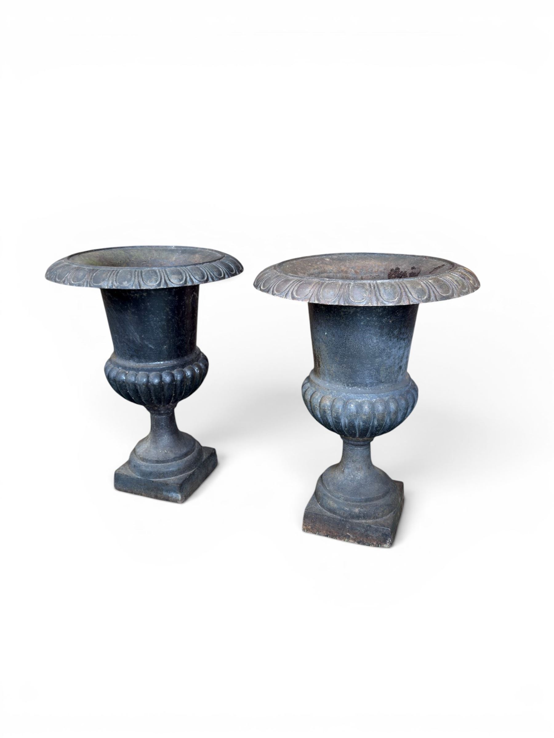 Pair of Victorian design heavy cast iron garden urns, black painted, egg and dart rim on waisted column