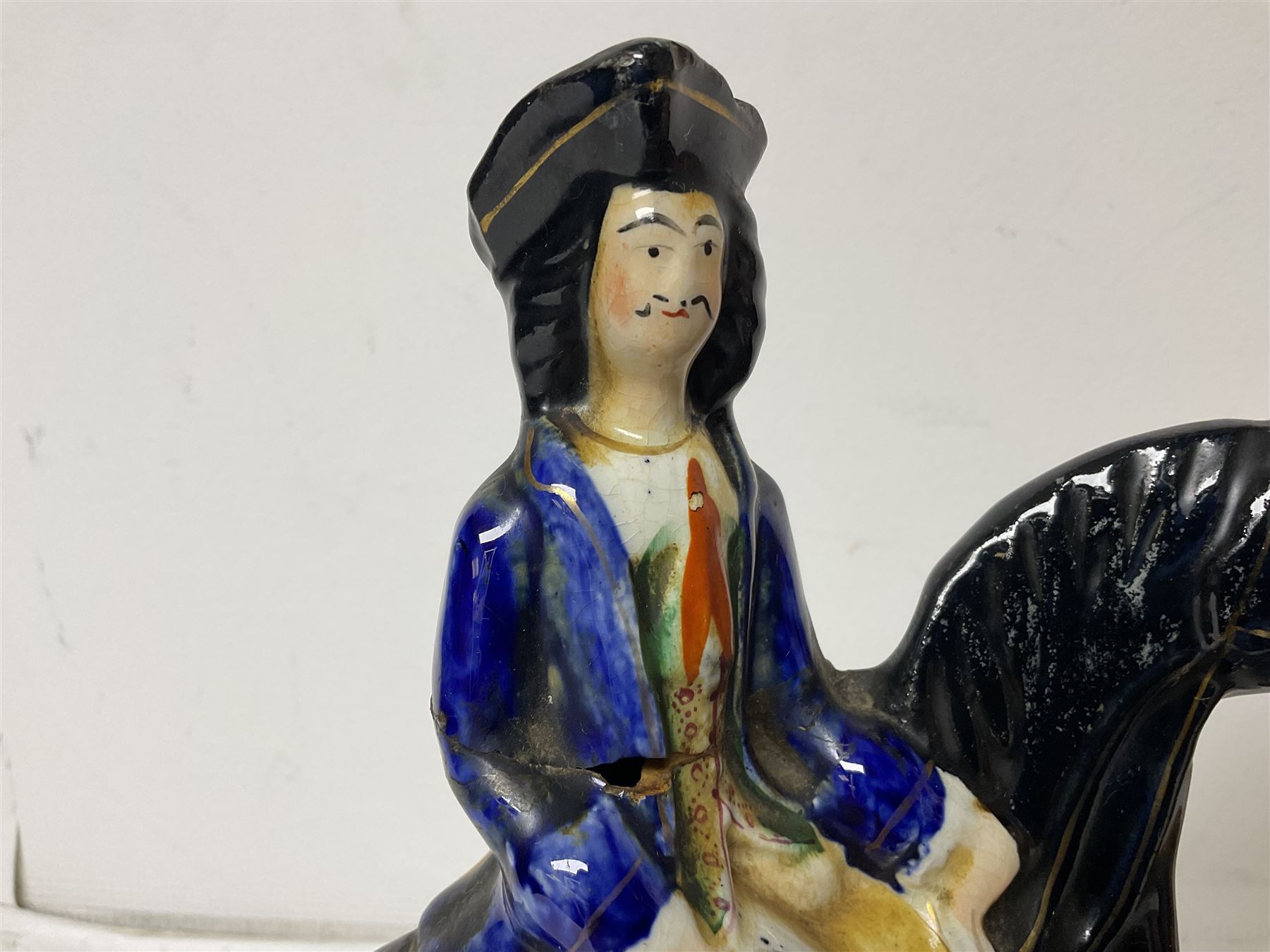 Staffordshire figure of the Duke of Wellington on a bay horse, H30cm in red uniform, together with a similar Staffordshire figure of Dick Turpin, pair of Staffordshire style dogs, H27cm, three Meissen style double salts and two trinket boxes 