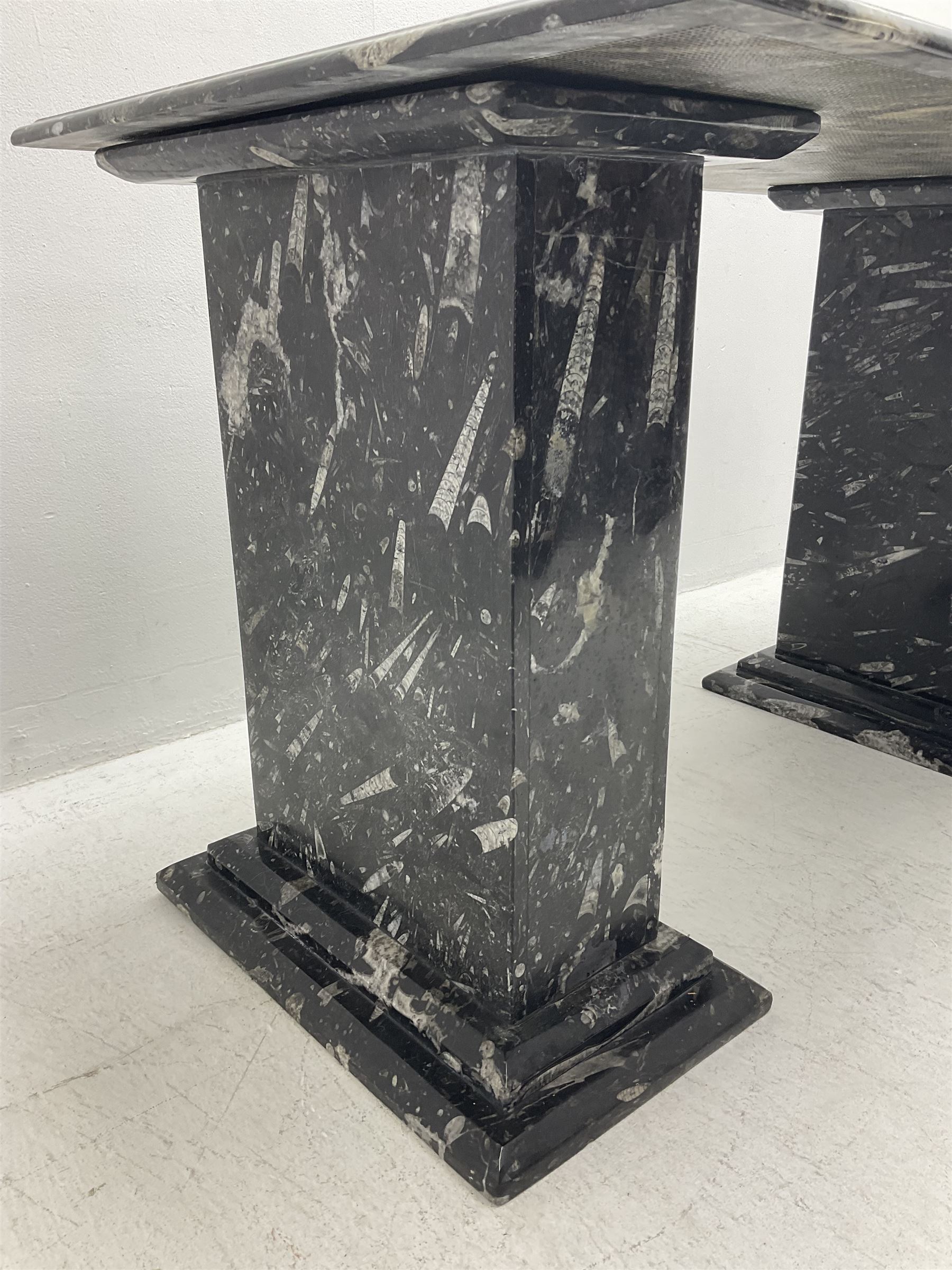 Marble hall table with orthoceras and goniatite inclusions, the rectangular top upon two rectangular stepped plinths, H75cm, L135cm, D78cm 