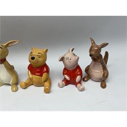Seven Beswick Winnie the Pooh figures, comprising Pooh Bear, Tigger, Piglet, Kanga, Mr Rabbit, Owl, and Eeyore, together with two Royal Doulton Winnie the pooh Christmas Collection figures, 'The Most Perfect Tree in all the Wood', and 'Christopher Robin Dresses the Tree', (9)  