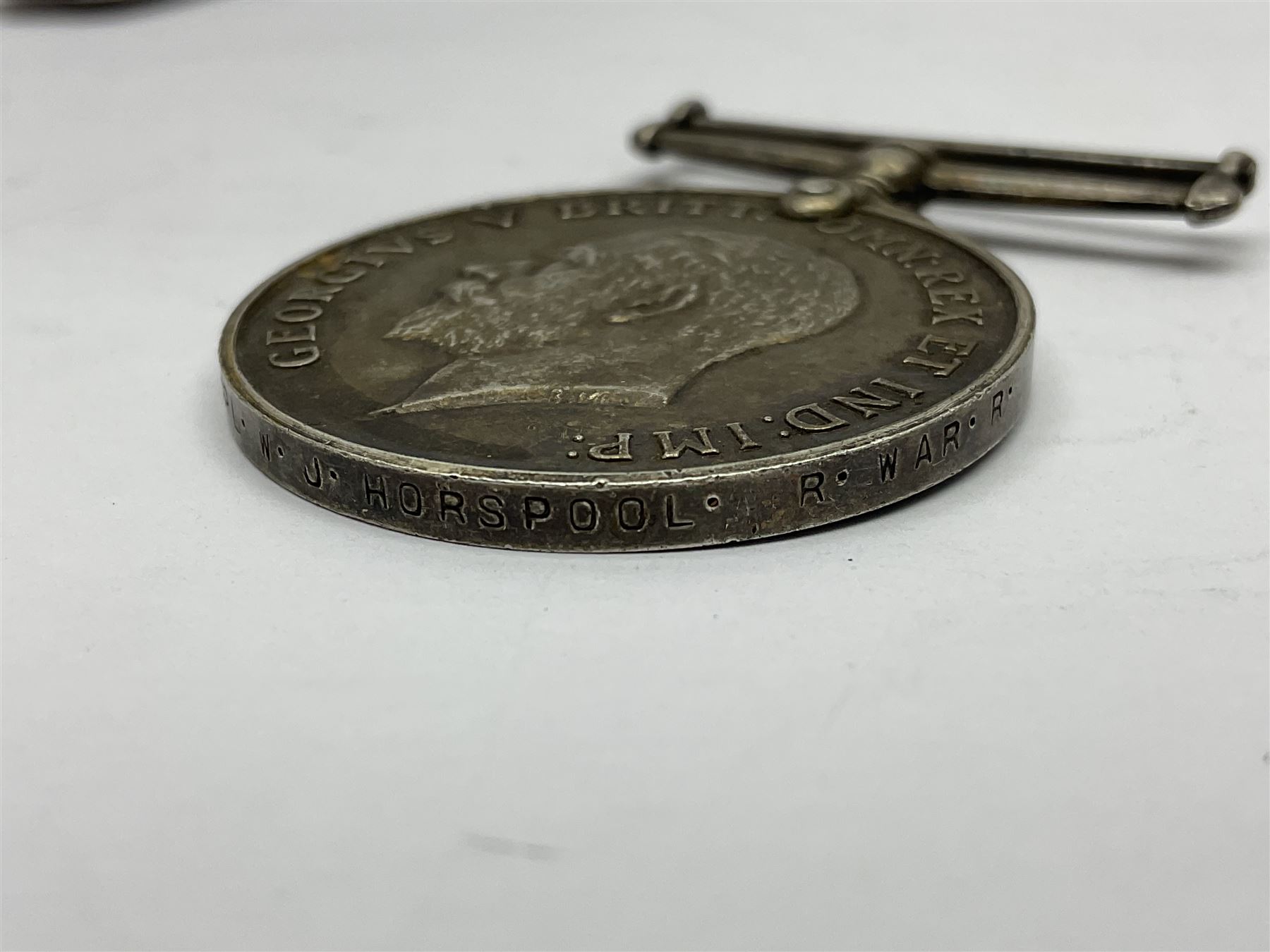 WW1 group of three medals comprising 1914-15 Star awarded to L-Cpl. W.J. Horspool R.War.R., British War Medal and Victory Medal awarded to A. Cpl. W.J. Horspool R.War.R.; WW1 British War Medal awarded to 3-8755 W.O.Cl.2. S. Paterson North'd Fus.; and hallmarked silver and enamel Northumberland Football Association Junior Cup Runners Up fob 1921-22 on silver chain (5)