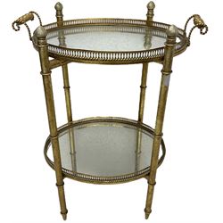 Gilt metal oval stand, two mirrored tray tiers with raised pierced galleries
