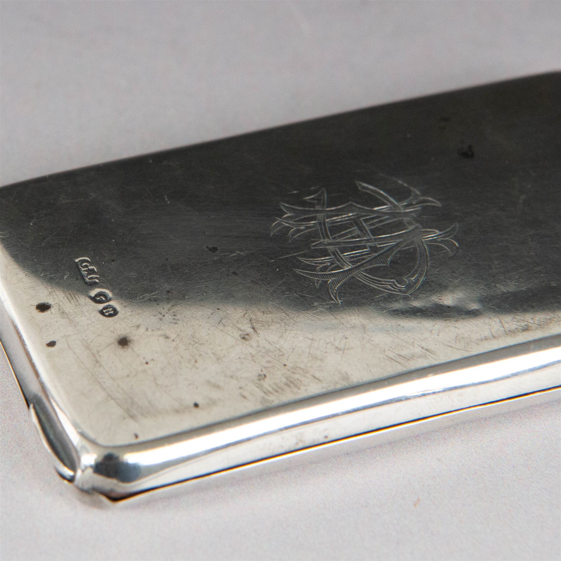 Two silver stamp cases, comprising Victorian silver mounted example with leather interior and engraved monogram to cover, hallmarked George Unite, Birmingham 1897, and a 1920s sliding example with engine turned decoration and vacant cartouche, hallmarked Sydney & Co, Birmingham 1924