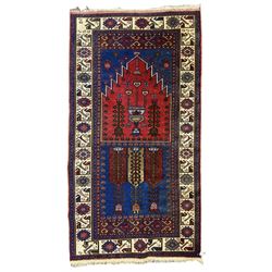 Turkish Yuruk indigo ground rug, the field decorated with geometric architectural designs, the guarded ivory border with repeating stylised plant motifs