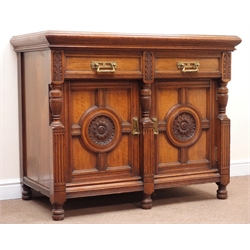  Edwardian oak sideboard, two drawers above two cupboards enclosing lead lined wine cooler and two sliding trays, turned supports, stamped and labelled 'Maple & Co', W124cm, H101cm, D64cm  