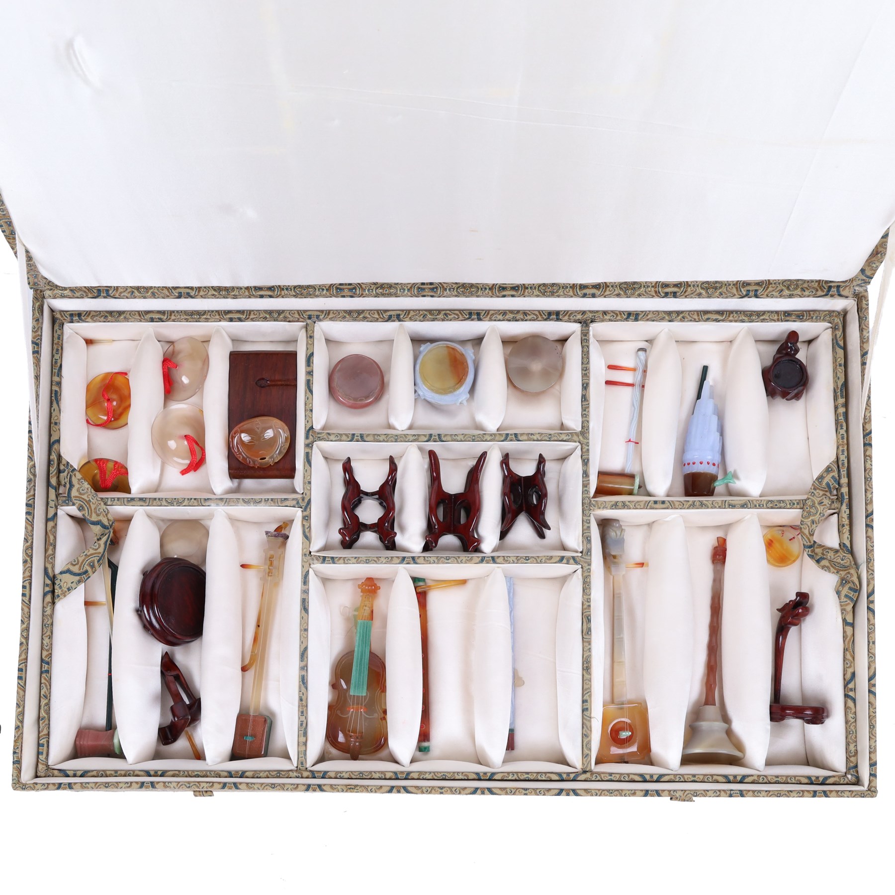 Boxed set of Chinese miniature polished hardstone musical instruments with hardwood stands